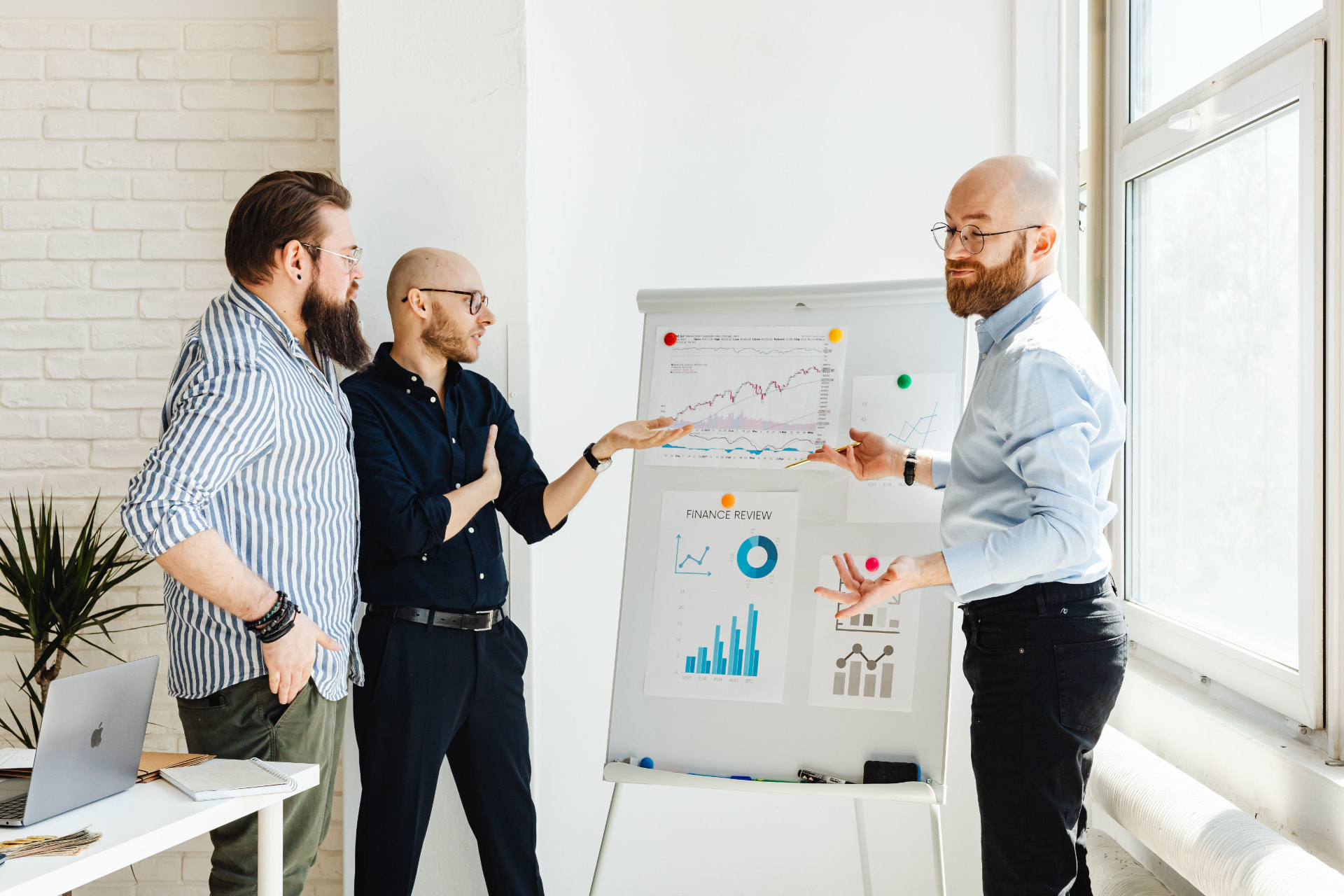 Sales team reviewing performance charts together on a whiteboard