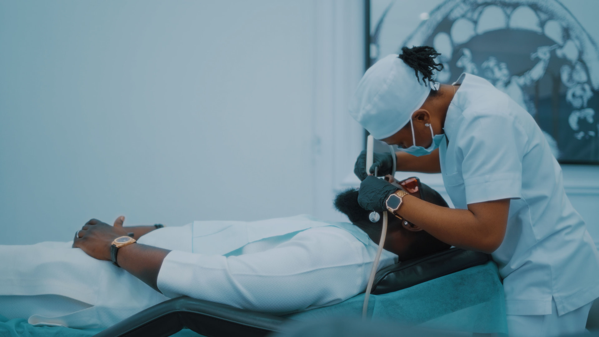 A dental team treating a patient in a modern operatory