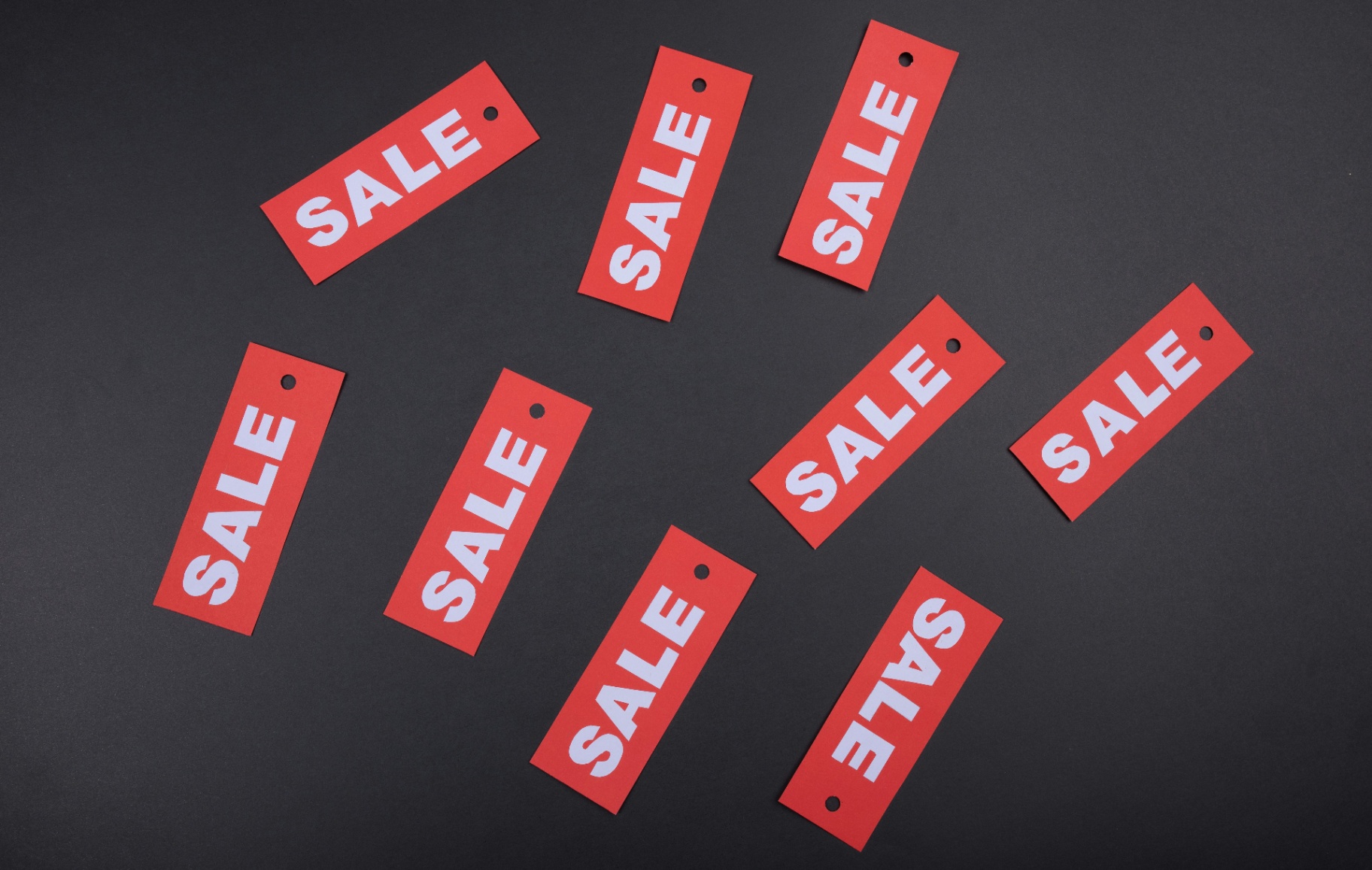 Sale tags representing sales recruiting fee models and pricing structures