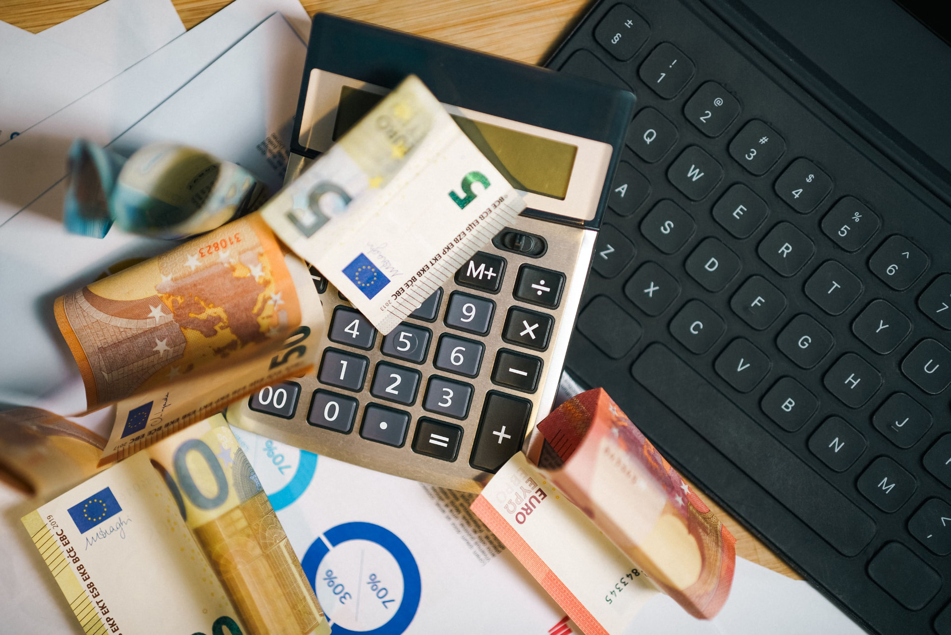 Cash, charts, and a calculator used to budget for a sales hire