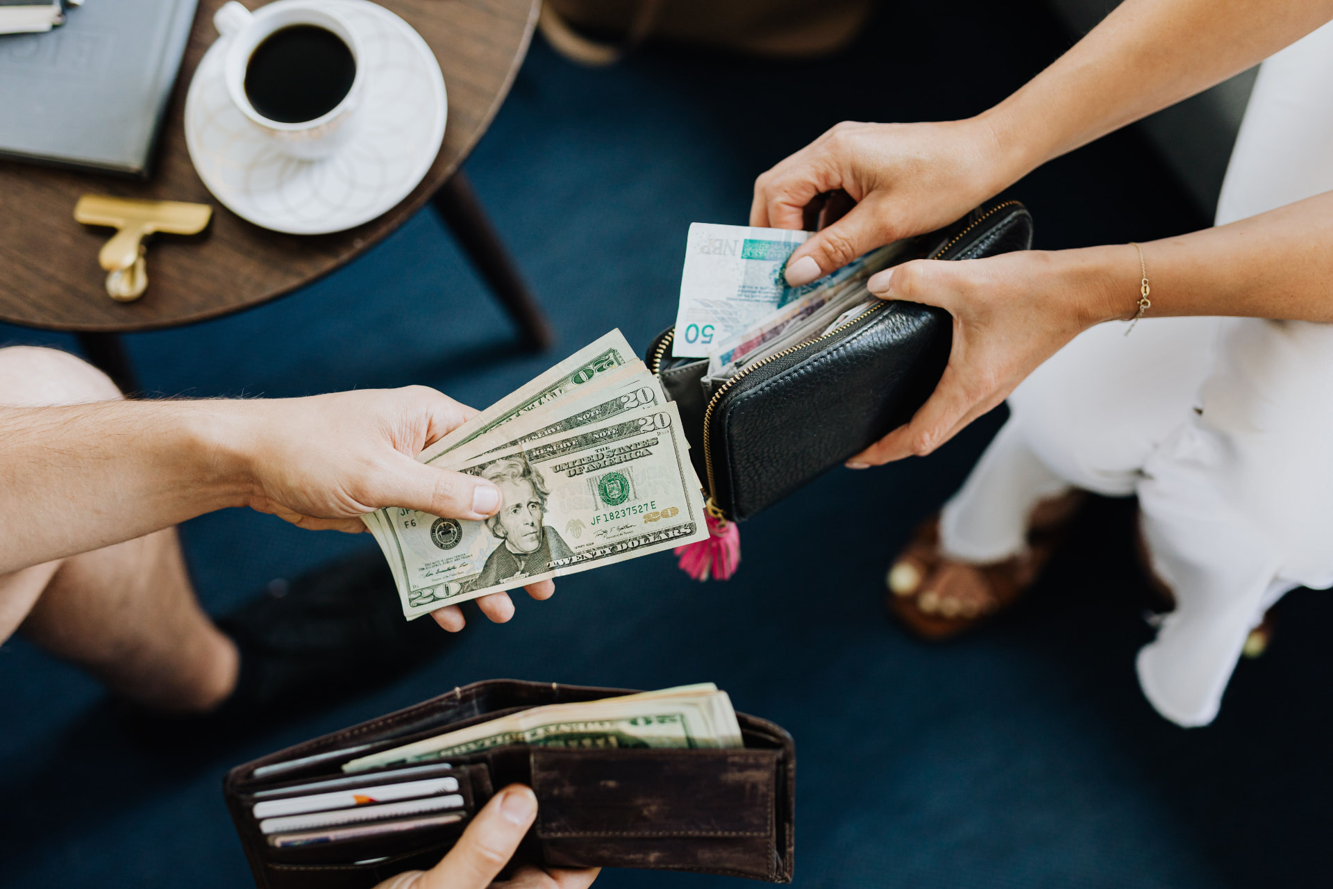Cash changing hands between two people during a payment