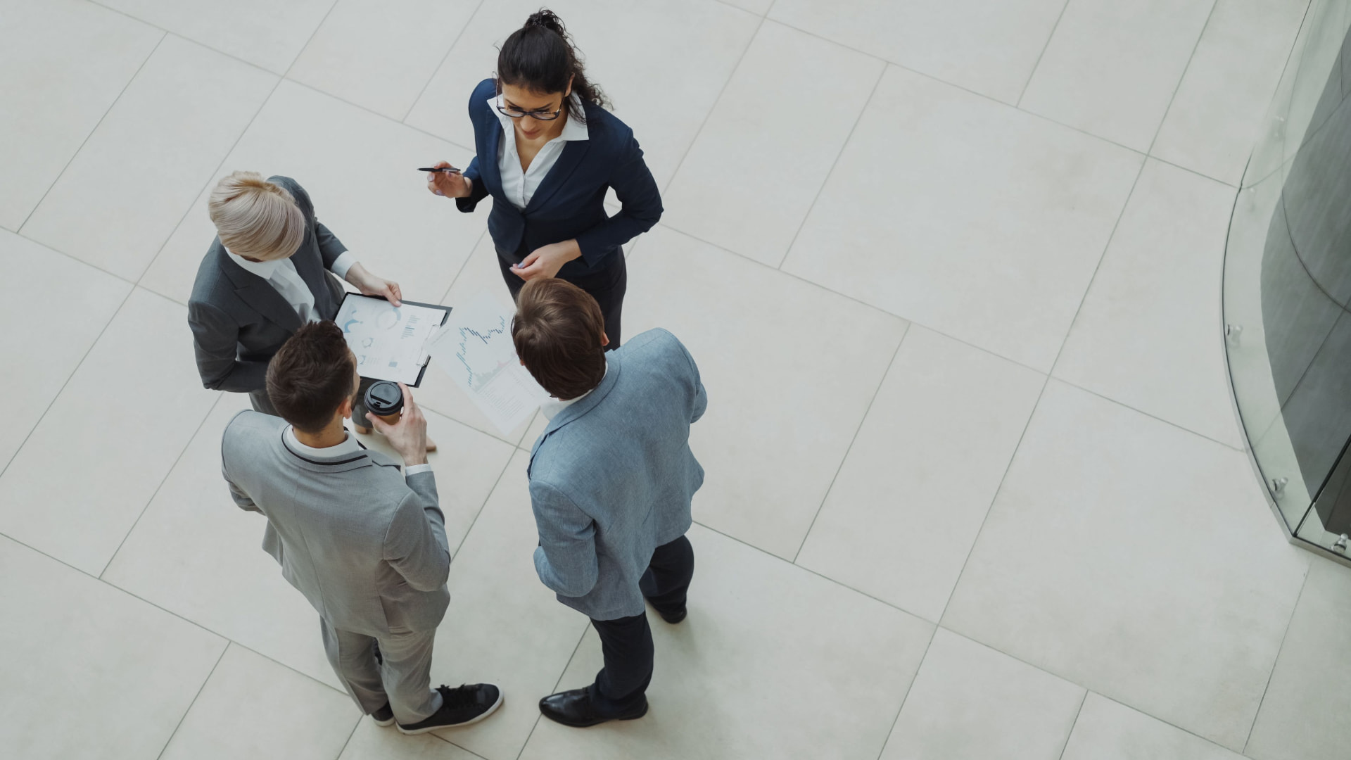 Business team meeting in an office lobby to review hiring plans