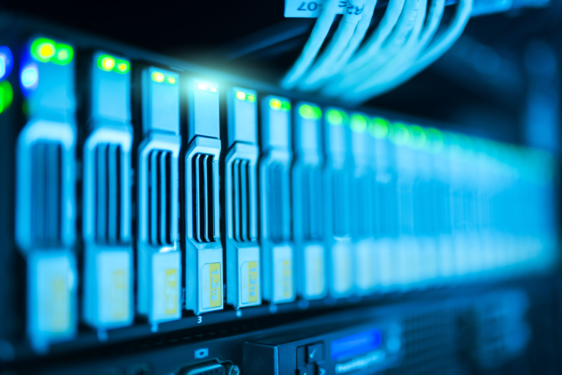 Server hardware illuminated in blue representing software and technology infrastructure