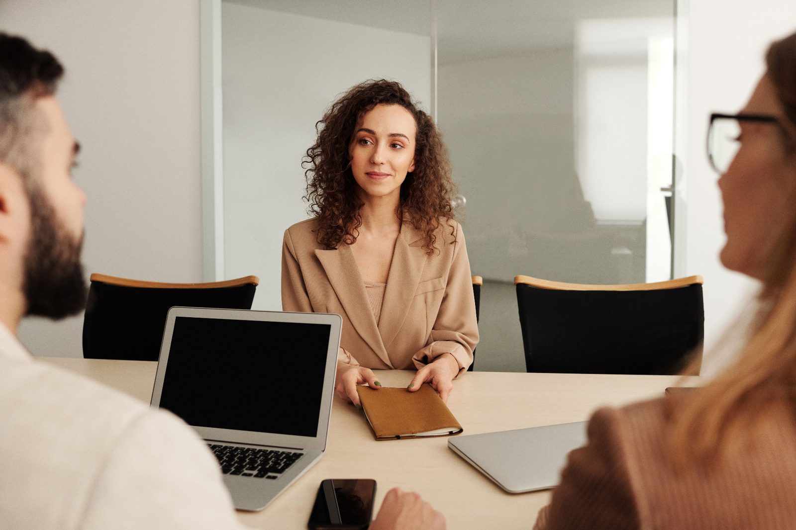 A hiring leader reviews recruiter fee structures and placement economics in a meeting